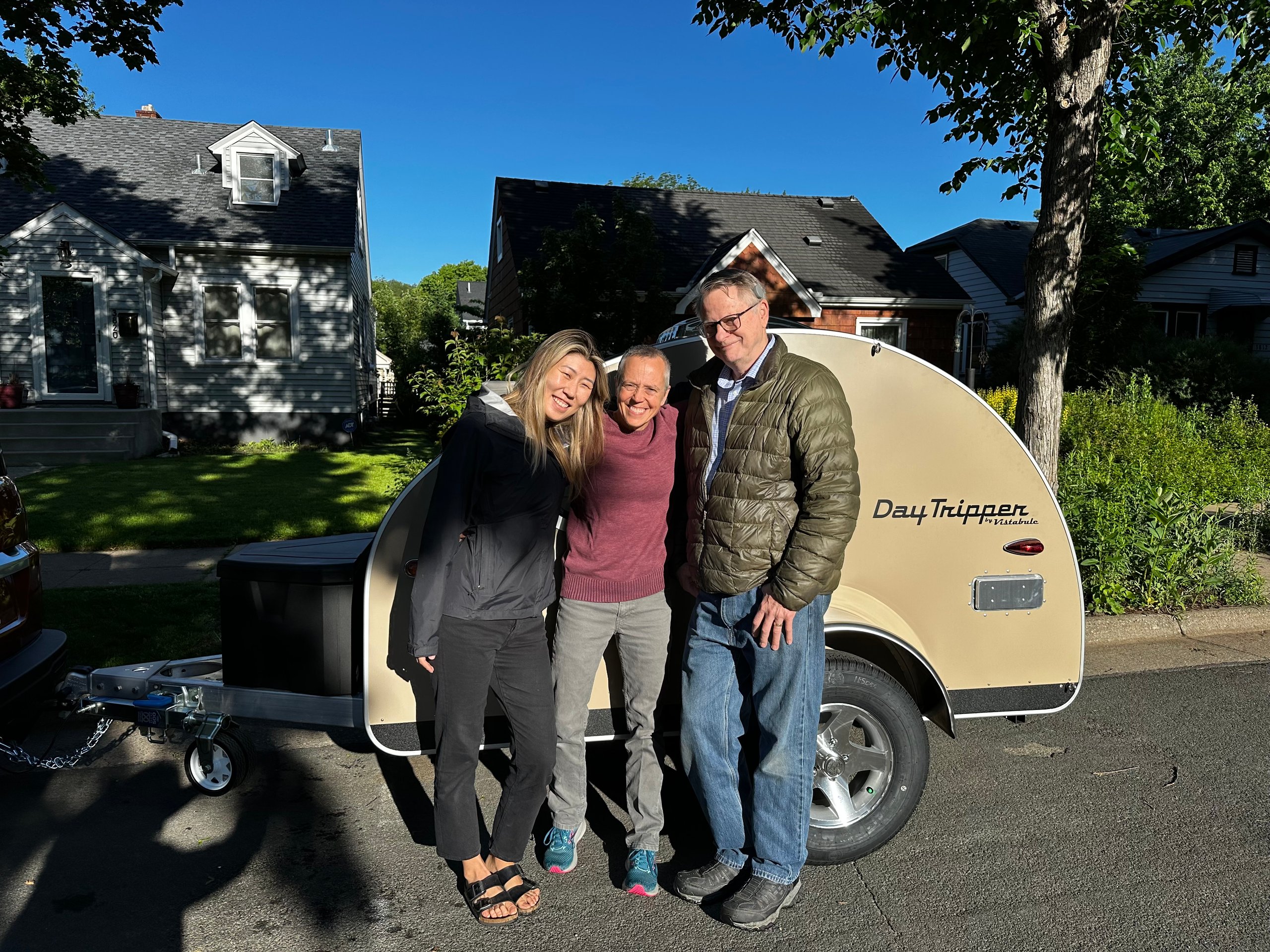 Three People In Front Of A Trailer